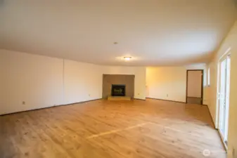 Upper Floor Huge Rec/flex space with another bedroom in the distance.  Doors to upper deck overlooking backyard