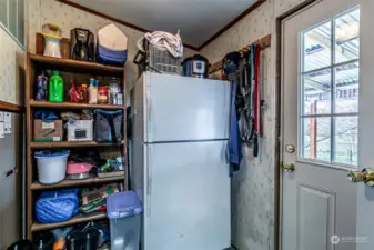 Mud Room & storage. Room for freezer or extra frig. Back door goes to fenced area for animals. Covered porch/deck.