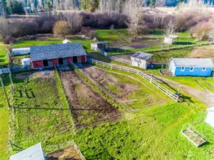 Barn with 3 12'x12' stalls and 3 20'x80' paddocks, fenced. New 30 yr composition roof 2023.