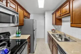 Full size appliances make food storage, prep and cooking a breeze. At the far end of the kitchen is pantry storage.
