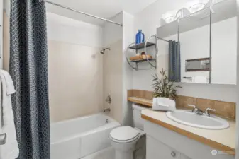 The full bath is located in the hall, just outside the bedroom and only steps from the living areas.