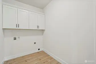 large laundry with shelving.