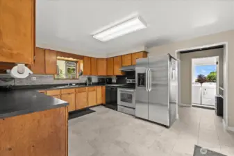 New tile kitchen leading to bathroom/ utility area.