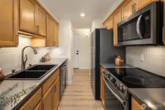 Gorgeous kitchen with stainless steel appliances, quartz counters and custom-built cabinets