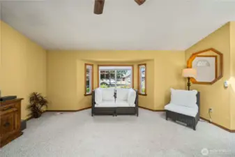 Living room facing the lovely bay window showcasing the front yard.