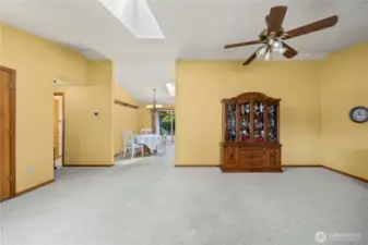 Living room showing coat closet to the left, dining area straight ahead and the hallway leading to the 3 bedrooms and 2 bathrooms shown on the left.