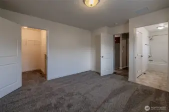 Primary bedroom with walk in closet and bonus storage space