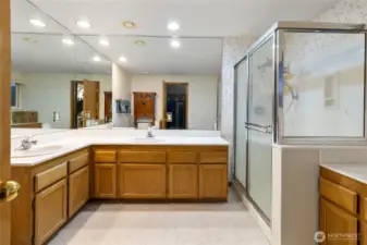 Double-sink vanity with plenty of storage and walk-in shower