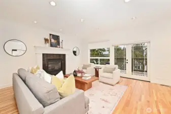 The main house living room has beautiful hardwood floors and a gas fireplace.