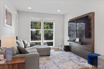 Spacious living area with built-in entertainment cabinet.