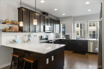 Beautiful chef's kitchen with qaurtz counters, SS appliances, walk-in pantry & ample cabinetry.