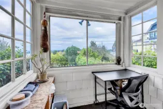 Little sunroom off of kitchen overlooking back garden & gazebo.