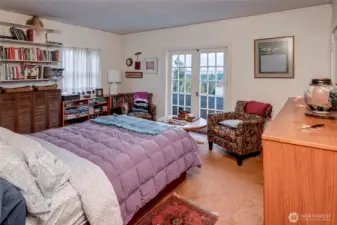 Primary bedroom with large walk-in closed.  French Doors open to patio looking to the Lake & Cascades.