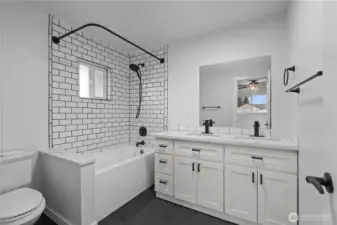 Primary en-suite with double sinks and soaking tub.