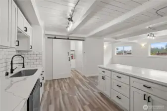 Kitchen with bar seating,  new stainless steel appliances and a large butler's pantry.