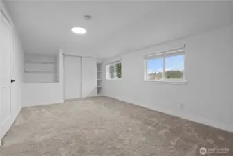Second upstairs bedroom with cute alcove shelving.