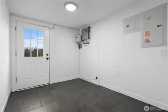 Mud room leads to separate fenced back yard, perfect for a dog run.