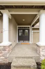 A beautiful covered entryway offers a warm and welcoming first impression.