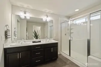 Luxurious primary suite with a spacious shower and bench — spa vibes