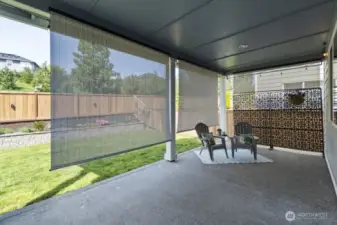 Relax year-round under a covered patio with privacy and heat shades