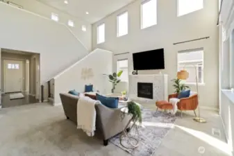Two-story living room windows with remote-controlled electric shades.
