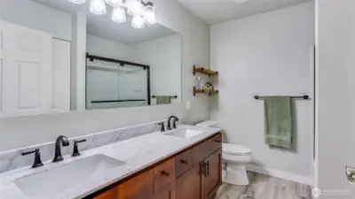 The primary full bath has been wonderfully up dated with Luxury vinyl flooring, Carrera marble counters, all new fixtures and shower.