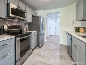Kitchen with Ceramic tile Flooring and Quartz Counters