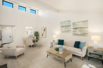 Another view of living and dining room towards front door and kitchen.