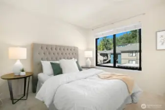 The second bedroom is spacious and filled with natural light, offering a warm and inviting atmosphere.