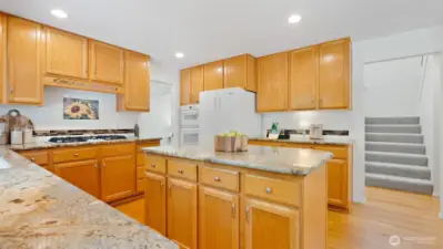 Yes - you’re cooking with natural gas! And just to the left of the refrigerator, the recently replaced wall oven and microwave make meal prep a breeze.