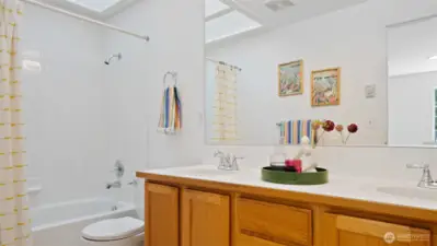 The upper hall bath is bright and inviting, thanks to a skylight that fills the space with natural light and a fresh coat of paint, "Snowbound."