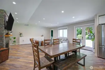 This bright and open living area features seamless indoor-outdoor flow through French doors to patio space and large backyard.