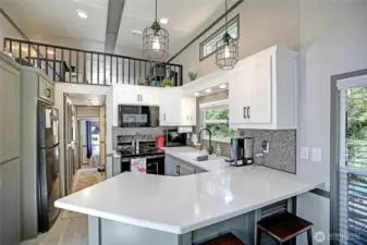 Great kitchen space has everything you need to live full time or the guest setup as well. Washer and dryer is just past the fridge as well.