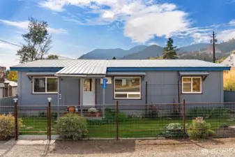 Streetside view of fenced in yard and territorial views.