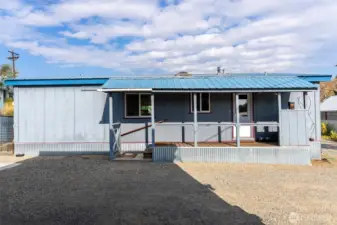 Back of house with extra parking space.