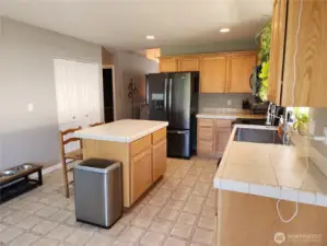 Pantry is in the kitchen across from the island.