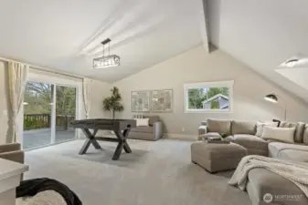 Another view of the bonus room that has access to the back deck and a second set of stairs leading to the lower level