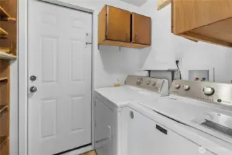 The laundry room is onveniently set between the home and the garage. Shelves and cabinets offer more storage!