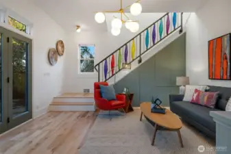Just refinished, beautiful maple floods. Metal storage on the stairwell and a colorful detailed, metal handrail.