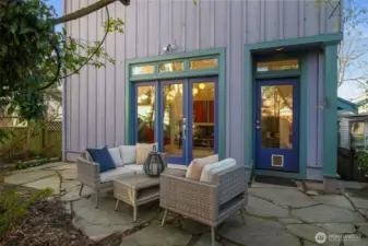 Back of the property with the addition. A good sized patio and fenced on both sides.