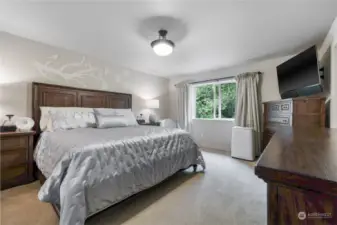 Upstairs is crowned with the primary suite, overlooking the woods and yard.