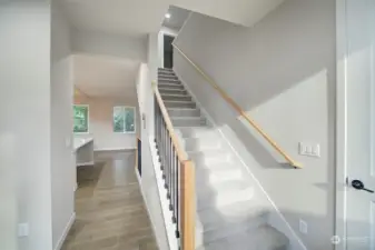 Up the stairs leads to your Primary En suite plus 3 beds, full bath & Laundry Room