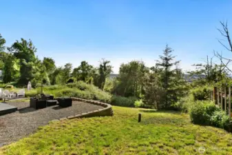 Stretch out and savor the view. This expansive backyard offers plenty of space to play, relax, or garden, all framed by mature trees and stunning westward vistas.