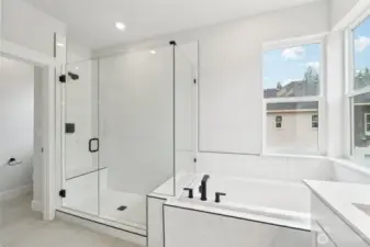 Soaking tub, frameless shower, extensive tile on floor and shower.