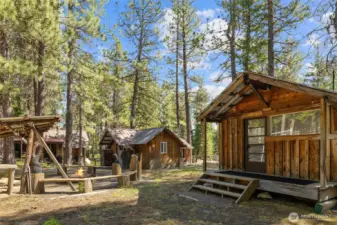 Studio cabin & main cabin with the firepit in the middle!