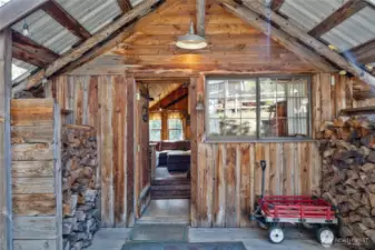 Main Cabin with cute covered entry, which also serves as great fire wood storage!