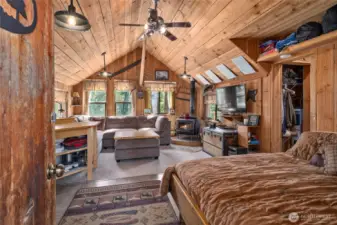 Main cabin in terior is so cute! T&G ceilings, kitchenette, living space with wood burning stove, large sleeping space & a full bath!