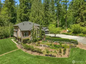 Beautiful gardens with berries and fruit trees throughout the property.