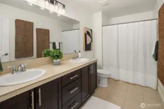 guest bathroom with dual vanities