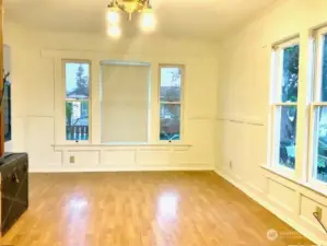 Spacious living room with beautiful sashed windows flood the room in natural light.